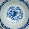 W936 Blue and white bowl, Kangxi (1662-1722), with lobed rim and molded sides, decorated with fish swimming among aquatic plants and water weeds, with a band of similar decoration to the inside rim.