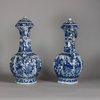W750 Pair of Chinese blue and white ‘phoenix-head’ ewers and covers, Kangxi (1662-1722), of octagonal ogee-shaped section with ribbed necks, flaring rims and ornate phoenix-form spouts; the bulbous bodies
