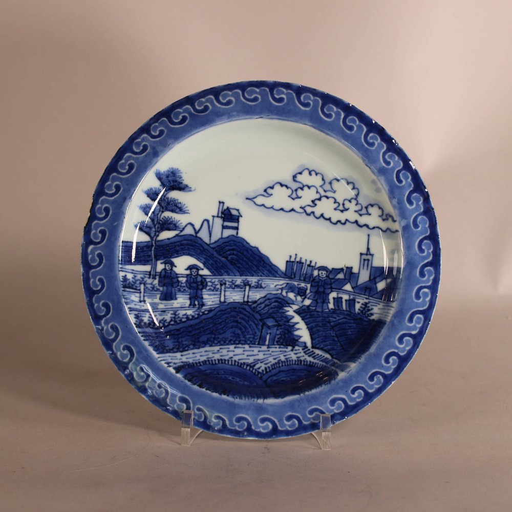 W909 Chinese blue and white Van Frytom style 'Deshima island' plate, 18th century, decorated in the centre with a Dutch marsh and coastal landscape with figures, a cow and the distant sails of ships, the r