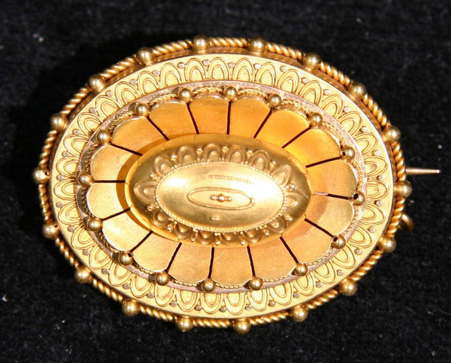 N263 Late Victorian gold cushion brooch of oval outline applied with