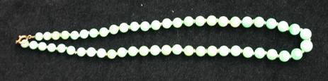 N922 Jade necklace of graduating beads, length: 19in., 48.4cm. 