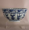 W874 Chinese late Ming bowl, Wanli (1573-1619), with moulded gently undulating sides and a foliate rim, the exterior painted in a bright cobalt blue with upright sprigs of flowering branches and perching b