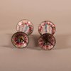 W917 A pair of Chinese Qianlong Canton enamel pricket candlesticks, the fluted tapering stems painted with panels of flowers in famille rose colours,