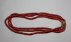 X824 Three strand coral bead choker with a filigree metal clasp